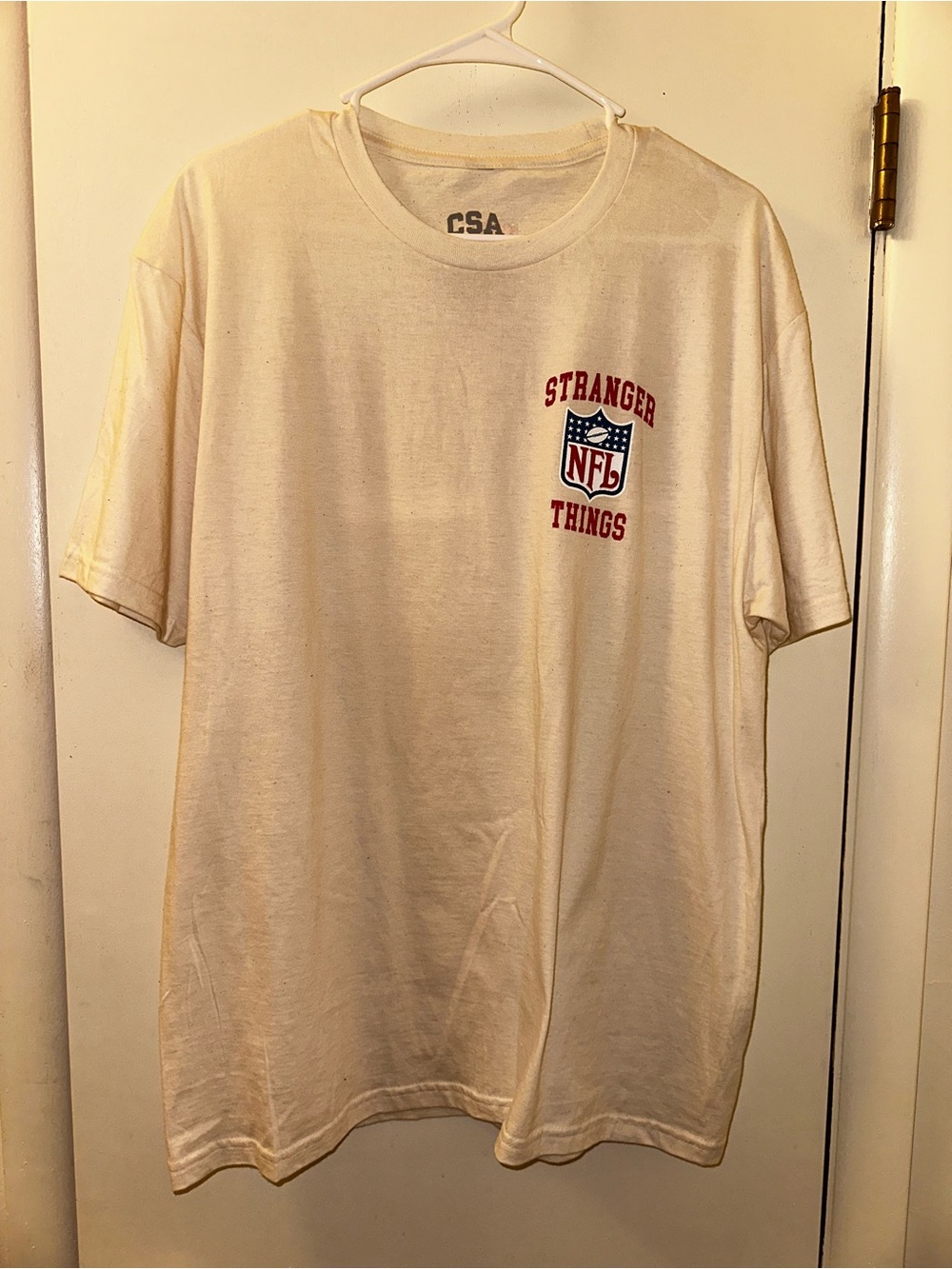 NFL Stranger Things Cream Short Sleeve Tee with Red Logo
